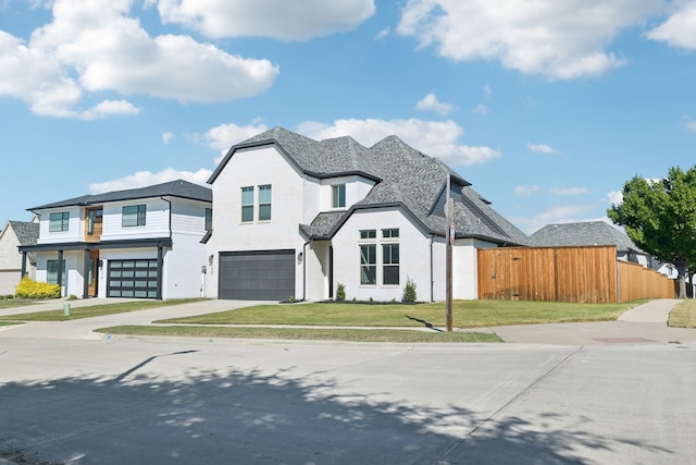 view of front of property with a front yard and a garage