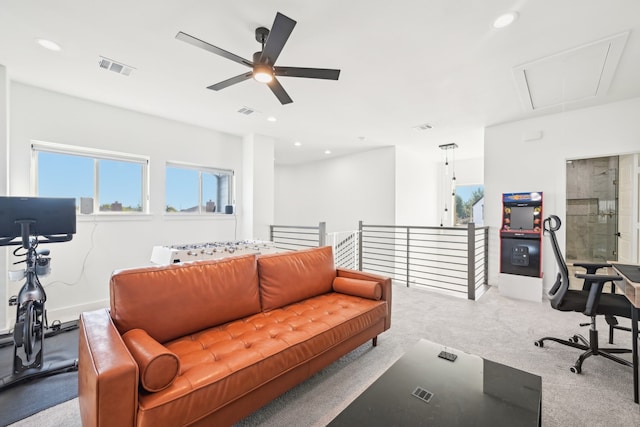 carpeted living room with ceiling fan