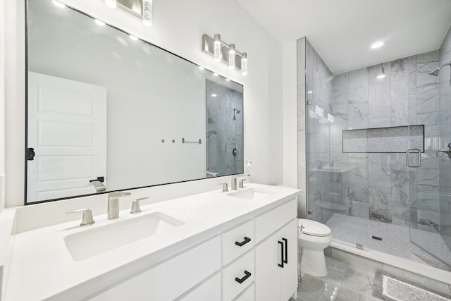 bathroom with vanity, toilet, and a shower with shower door