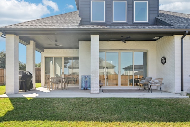 rear view of house with a patio, a yard, and ceiling fan