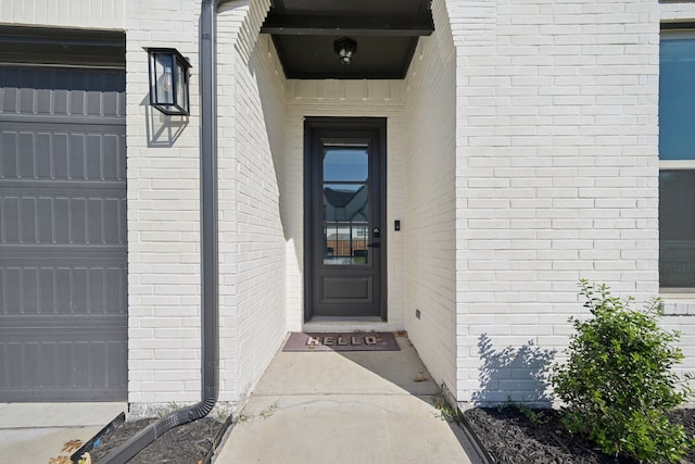 view of exterior entry featuring a garage