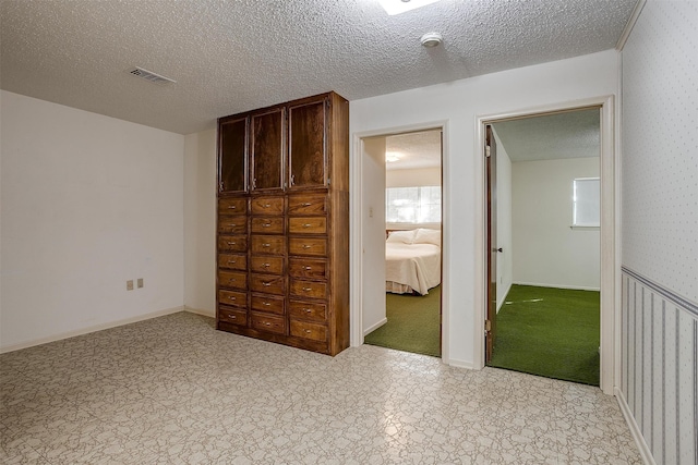 unfurnished bedroom with a textured ceiling