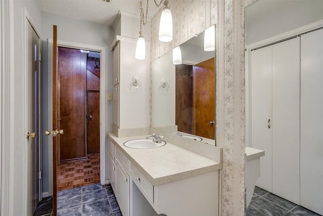 bathroom featuring vanity, a textured ceiling, and parquet floors