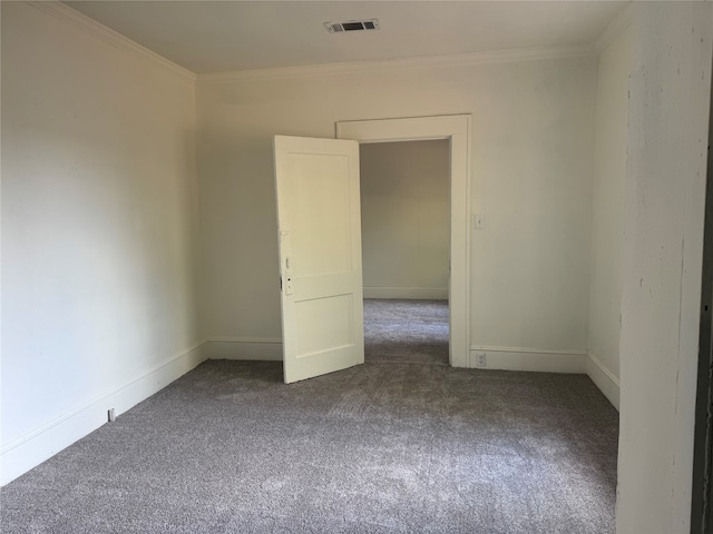 unfurnished room with crown molding and carpet floors