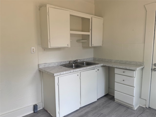 kitchen featuring sink, hardwood / wood-style floors, and white cabinets