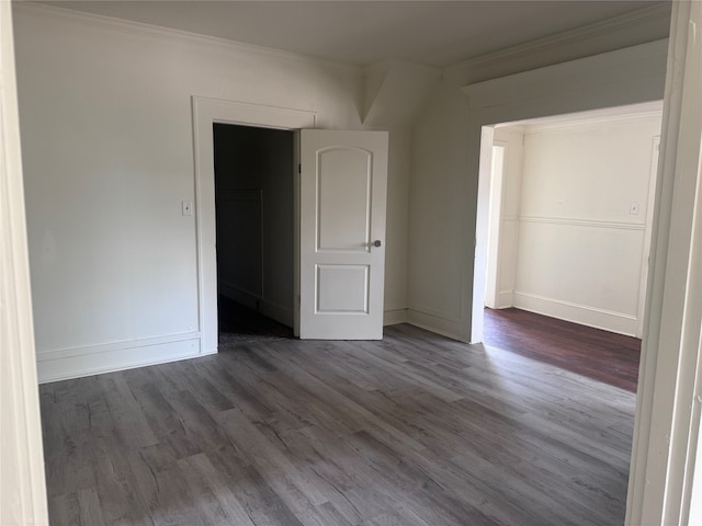 empty room featuring ornamental molding and wood-type flooring