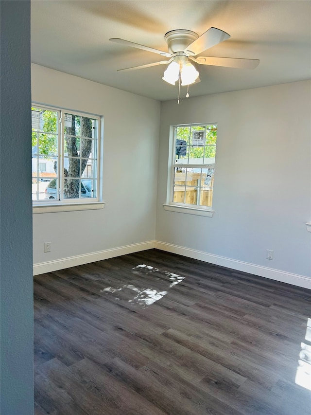 empty room with dark wood-type flooring and ceiling fan