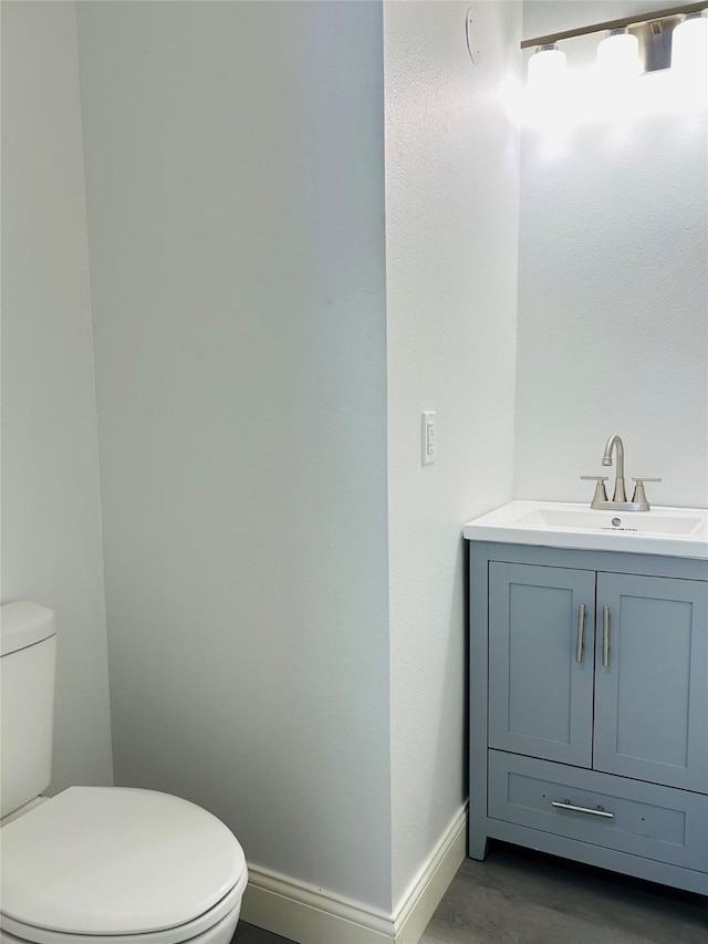 115 Whitham St, Irving, TX 75060 - half bath featuring toilet, baseboards, and vanity