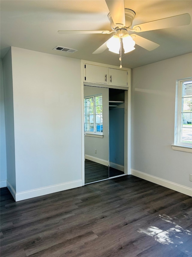 unfurnished bedroom with a closet, ceiling fan, and dark hardwood / wood-style floors