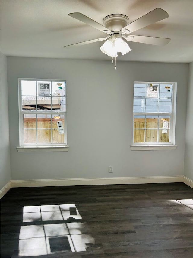 unfurnished room featuring ceiling fan and dark hardwood / wood-style flooring