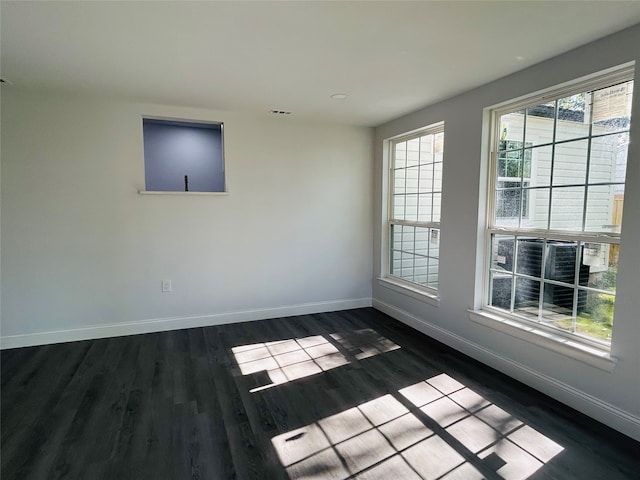 spare room featuring dark hardwood / wood-style flooring