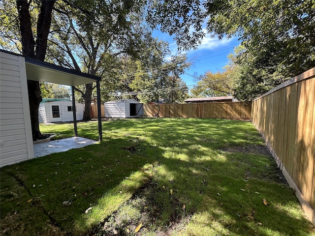 view of yard with a shed and a patio area