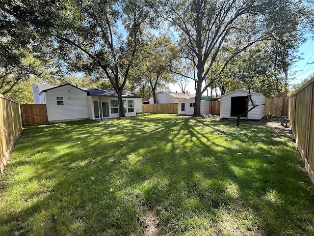 115 Whitham St, Irving, TX 75060 - view of yard featuring a fenced backyard, an outbuilding, and a storage shed