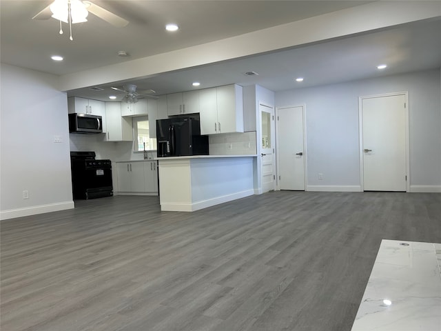 kitchen with hardwood / wood-style floors, black appliances, white cabinets, and ceiling fan