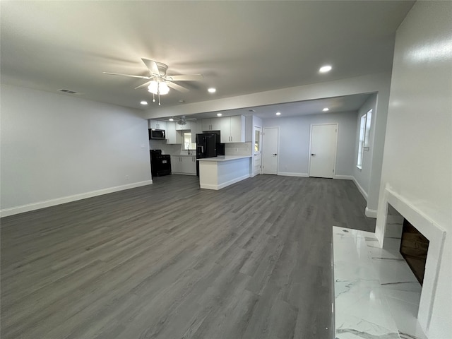 unfurnished living room with hardwood / wood-style floors and ceiling fan