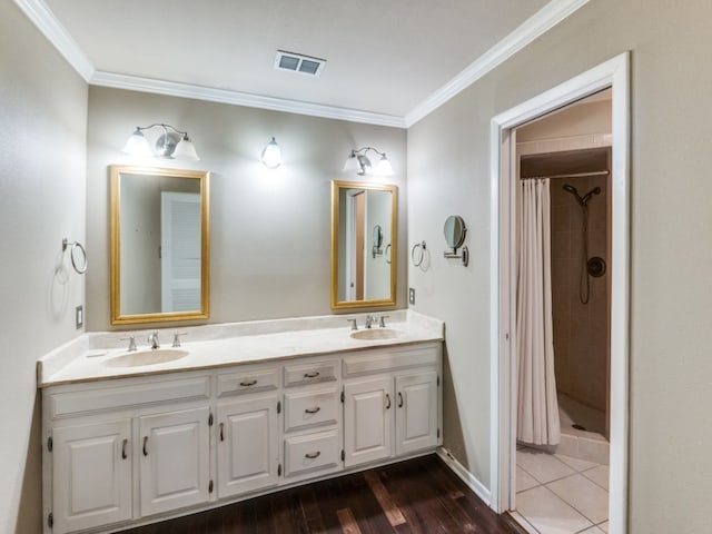 bathroom featuring vanity, crown molding, wood-type flooring, and a shower with curtain