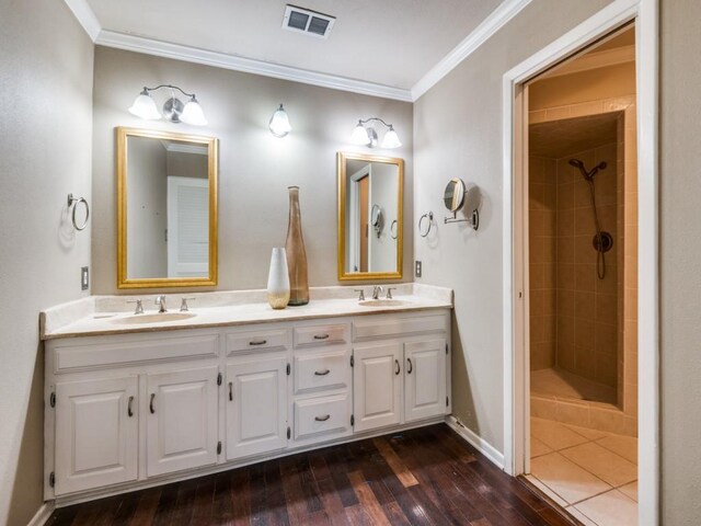 bathroom featuring a tile shower, toilet, and tile patterned flooring