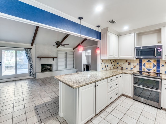 kitchen featuring appliances with stainless steel finishes, kitchen peninsula, decorative light fixtures, and white cabinetry