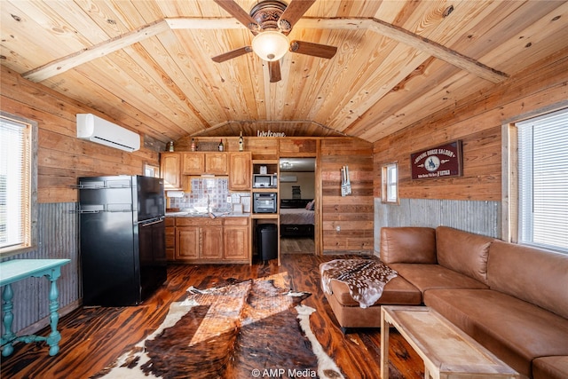 kitchen featuring lofted ceiling, wooden walls, a wall mounted air conditioner, and freestanding refrigerator