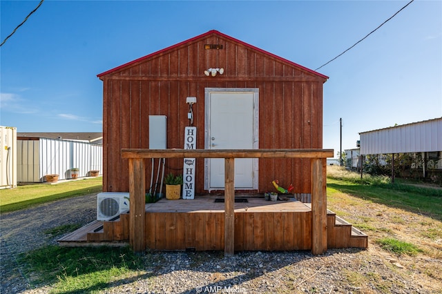 view of outbuilding with ac unit and an outdoor structure