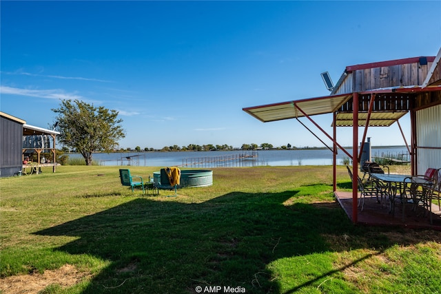 view of yard with a water view and a patio