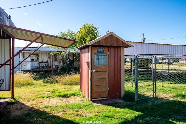 view of shed with a gate and fence