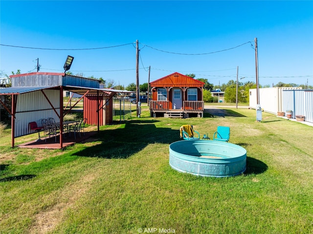 view of playground featuring a yard and a swimming pool