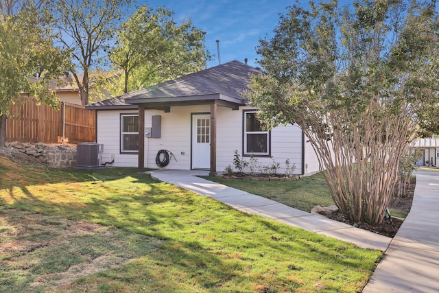 view of front facade featuring a front lawn and central AC unit