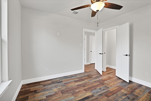 unfurnished bedroom featuring ceiling fan and dark hardwood / wood-style floors