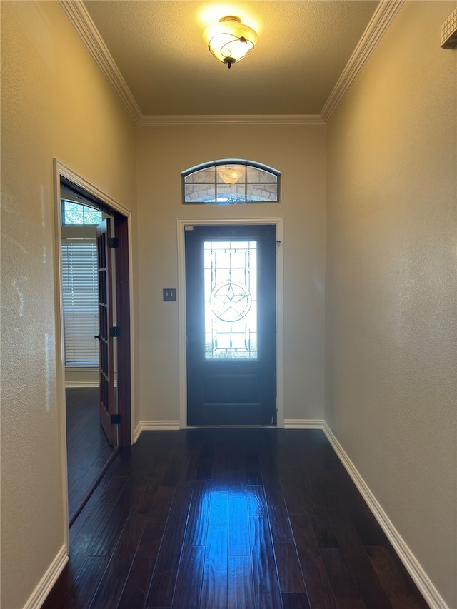 foyer entrance with dark wood-type flooring, crown molding, and a textured ceiling