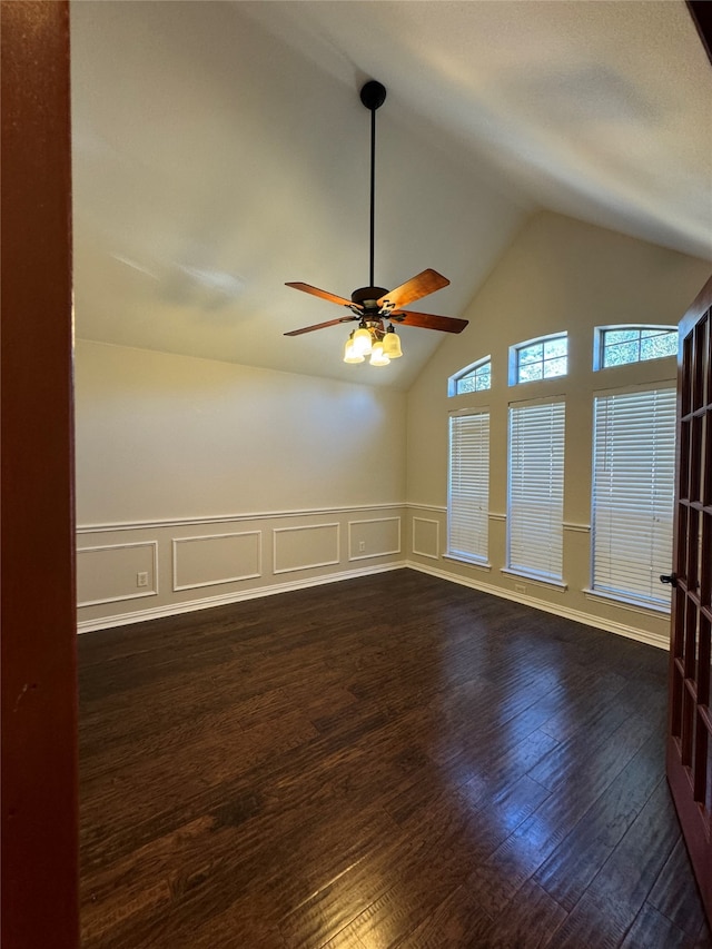 spare room featuring ceiling fan, lofted ceiling, and dark hardwood / wood-style flooring