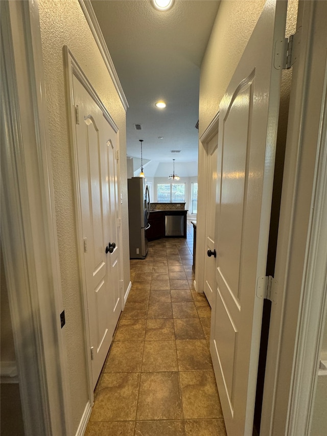 corridor with dark tile patterned flooring