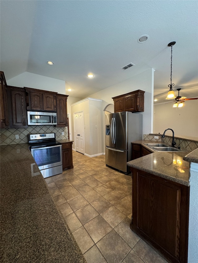 kitchen featuring decorative backsplash, sink, dark brown cabinetry, appliances with stainless steel finishes, and ceiling fan