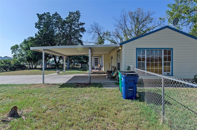 view of front of house with a front yard and a carport