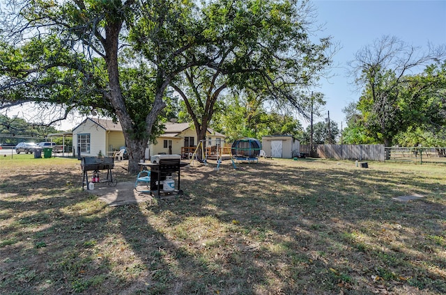 view of yard with a storage shed and a patio area