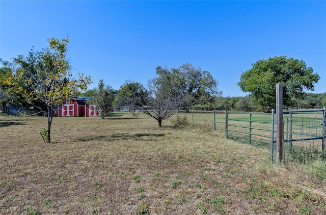 view of yard with a rural view and a shed