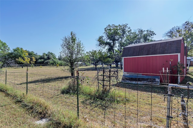 view of yard featuring an outbuilding and a rural view