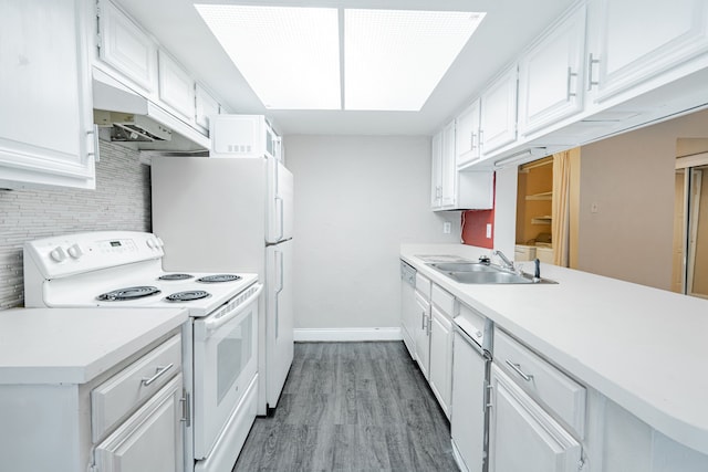 kitchen with backsplash, sink, white cabinets, light hardwood / wood-style floors, and electric stove