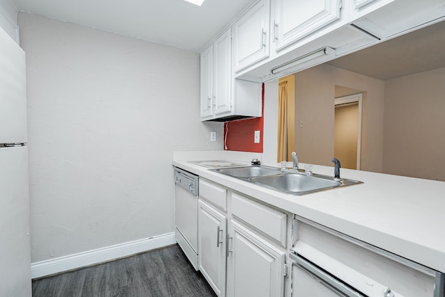 kitchen with dark hardwood / wood-style flooring, white cabinets, sink, and white appliances