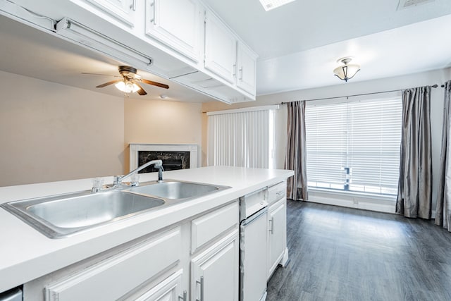 kitchen with sink, dark wood-type flooring, white cabinets, and ceiling fan