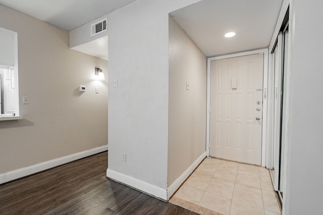 hallway with light hardwood / wood-style flooring