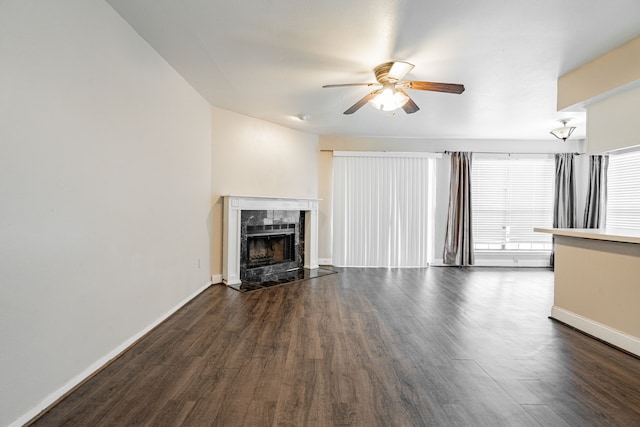 unfurnished living room with dark wood-type flooring, a fireplace, and ceiling fan