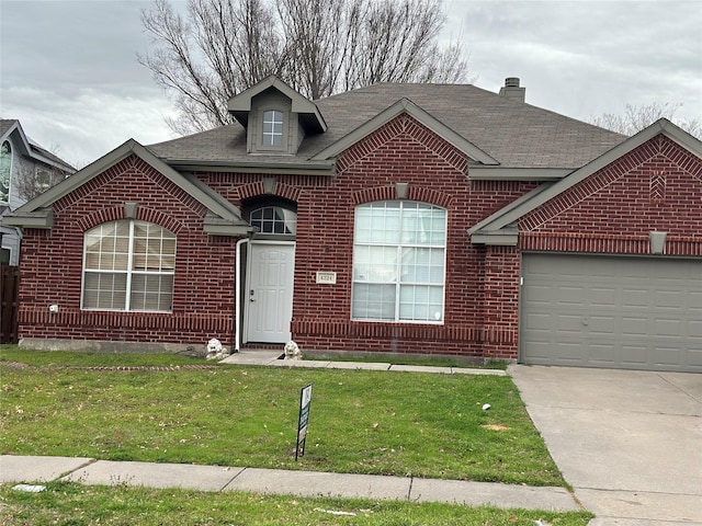 view of front of house featuring brick siding, roof with shingles, a garage, driveway, and a front lawn