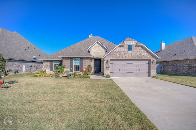 view of front of home featuring a front lawn and a garage