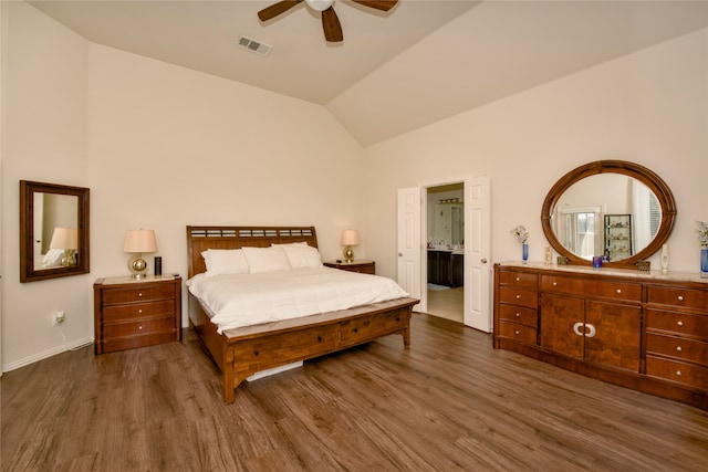 bedroom with connected bathroom, ceiling fan, vaulted ceiling, and dark hardwood / wood-style flooring