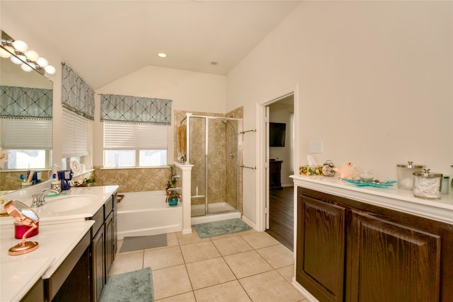 bathroom with vanity, independent shower and bath, lofted ceiling, and tile patterned flooring