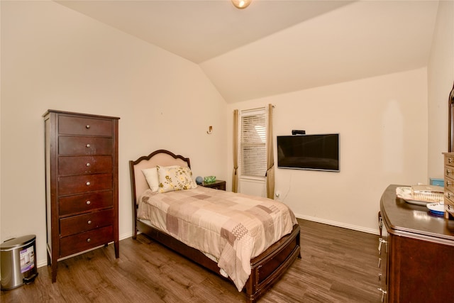 bedroom with lofted ceiling and dark hardwood / wood-style floors