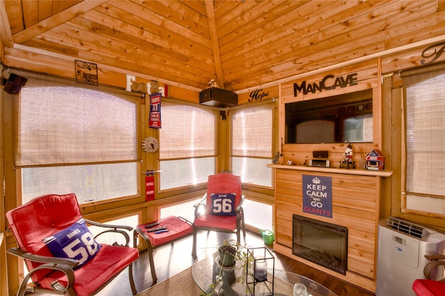 sitting room with hardwood / wood-style flooring, wooden ceiling, vaulted ceiling, and a fireplace