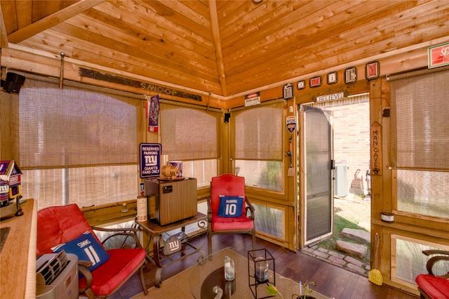 interior space featuring lofted ceiling, dark hardwood / wood-style floors, wood walls, and wood ceiling