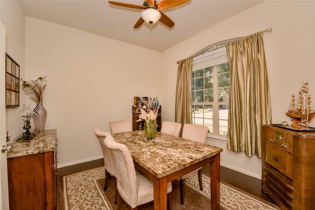 dining area with wood-type flooring and ceiling fan